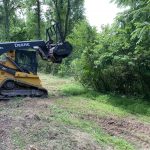 skid-steer loader clearing vegetation