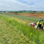 Helmick tractor mowing